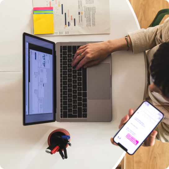 person talking on phone while searching on computer