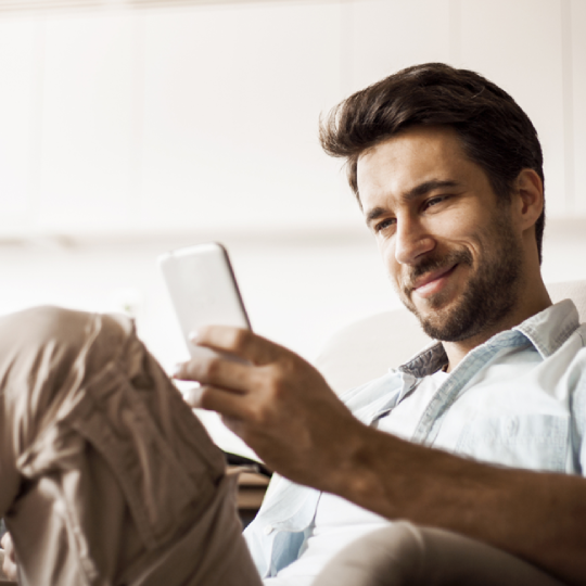 man smiling at proactive customer engagement message