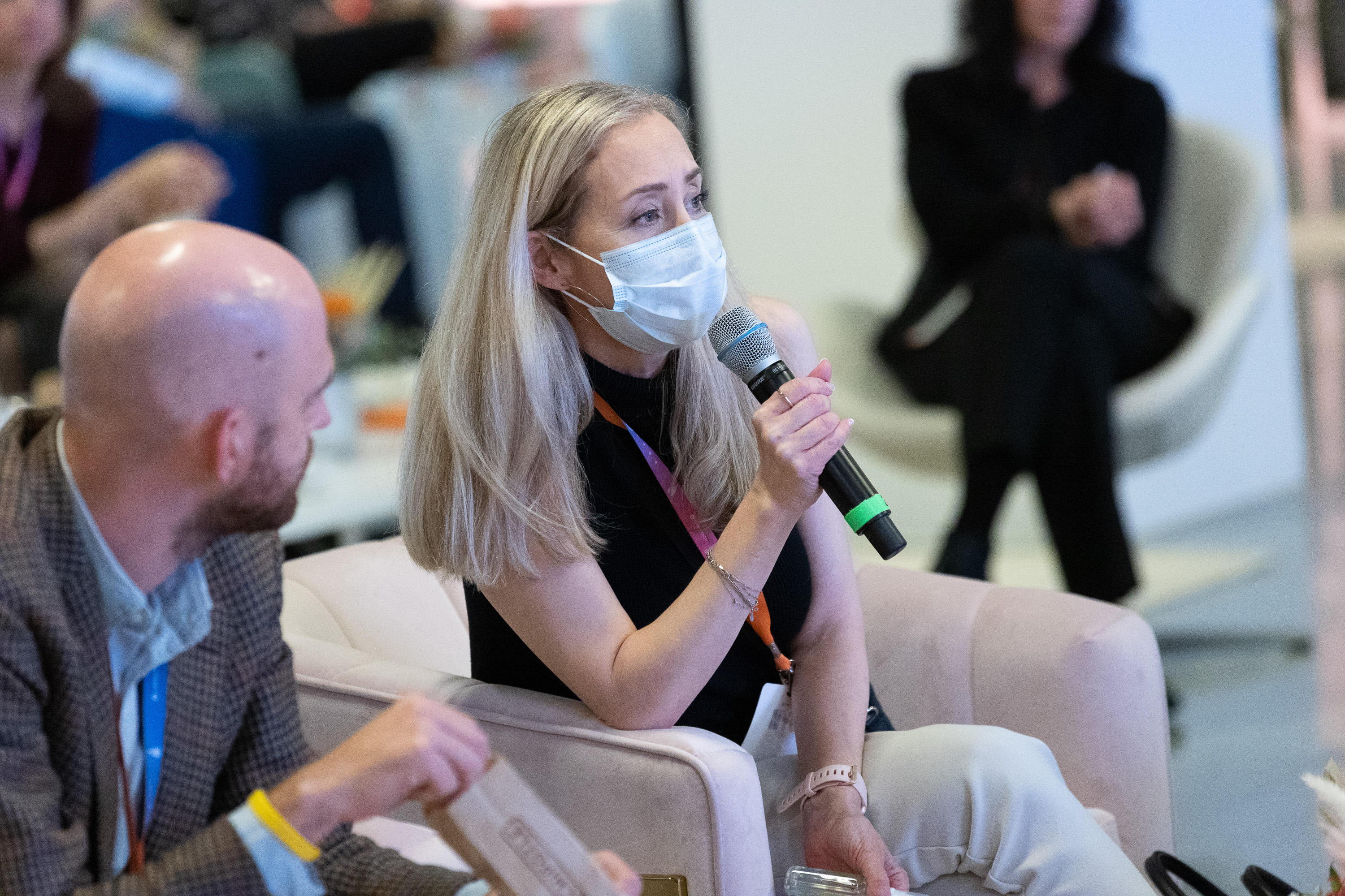 Event attendee in mask asking a question